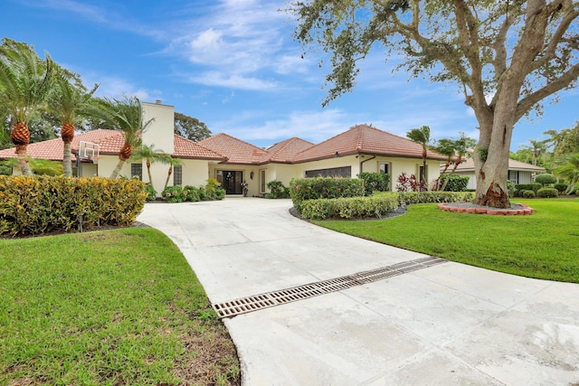 mediterranean / spanish home featuring a front yard