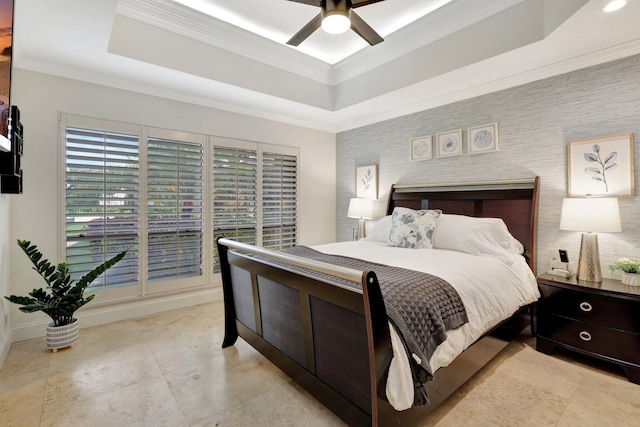 bedroom featuring ornamental molding, a raised ceiling, and ceiling fan