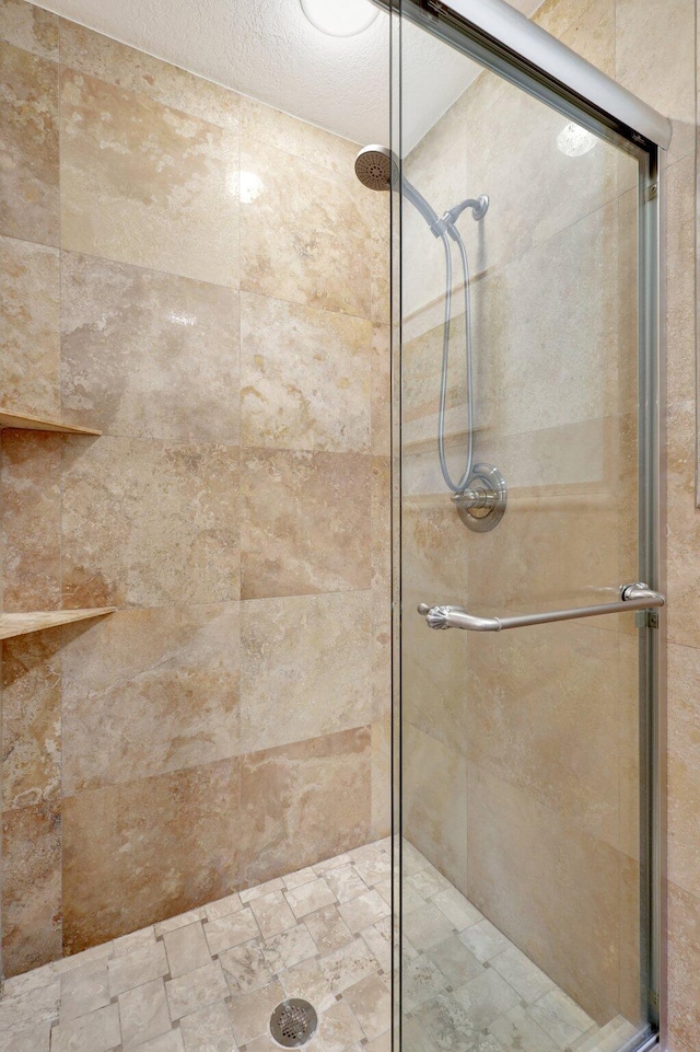 bathroom with a shower with shower door