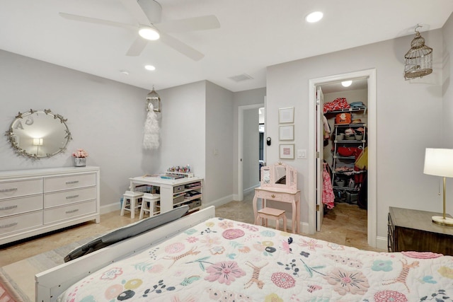 bedroom with ceiling fan, a spacious closet, and a closet