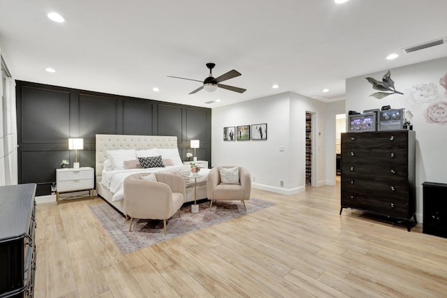 bedroom with light hardwood / wood-style flooring and ceiling fan