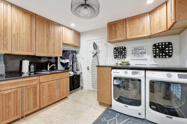 washroom with sink and washing machine and dryer