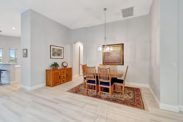 dining area featuring light wood-type flooring and a chandelier