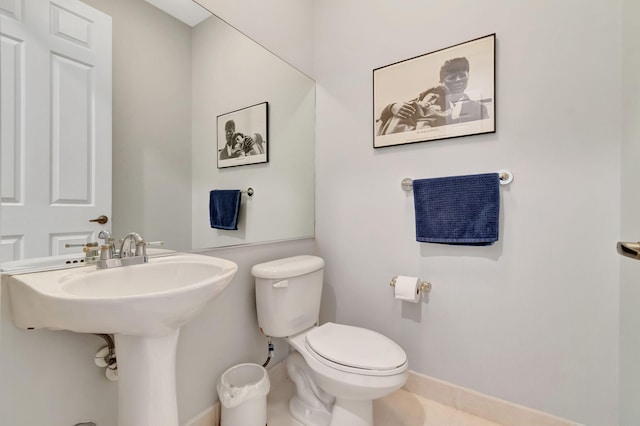 bathroom with toilet and tile patterned flooring