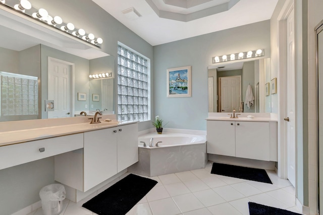 bathroom with a bath, tile patterned flooring, and vanity