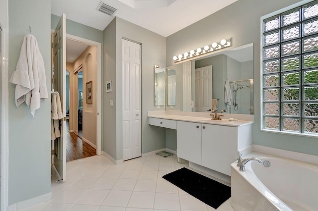 bathroom featuring a tub to relax in, vanity, and hardwood / wood-style flooring