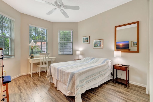 bedroom with ceiling fan and hardwood / wood-style floors