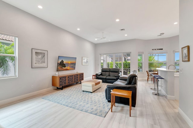 living room featuring ceiling fan and light wood-type flooring