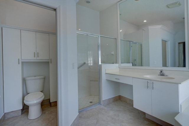 bathroom featuring tile patterned flooring, a shower with door, vanity, and toilet