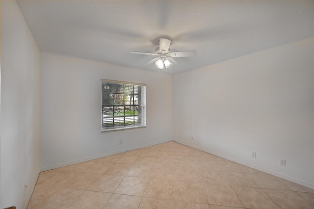 spare room featuring ceiling fan and light tile patterned flooring