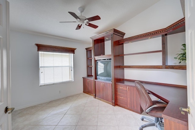 unfurnished office featuring ceiling fan, light tile patterned flooring, and a textured ceiling