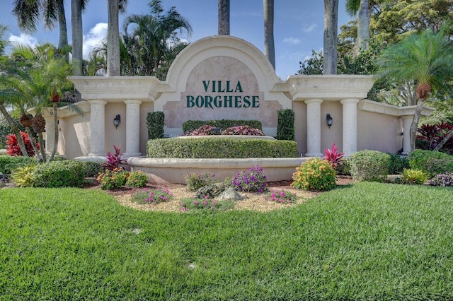 community / neighborhood sign featuring a lawn