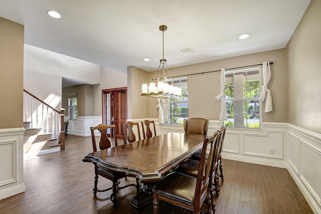 dining area featuring dark wood-type flooring and a healthy amount of sunlight