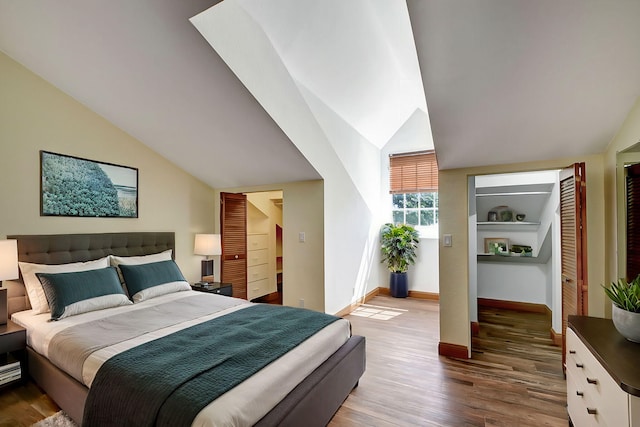 bedroom featuring hardwood / wood-style flooring and vaulted ceiling