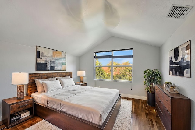 bedroom featuring dark hardwood / wood-style floors and lofted ceiling