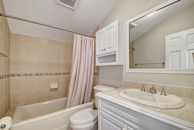 full bathroom with vanity, toilet, lofted ceiling, and shower / bath combo with shower curtain