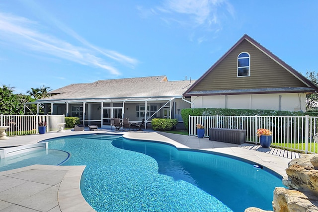 view of pool featuring a sunroom and a patio