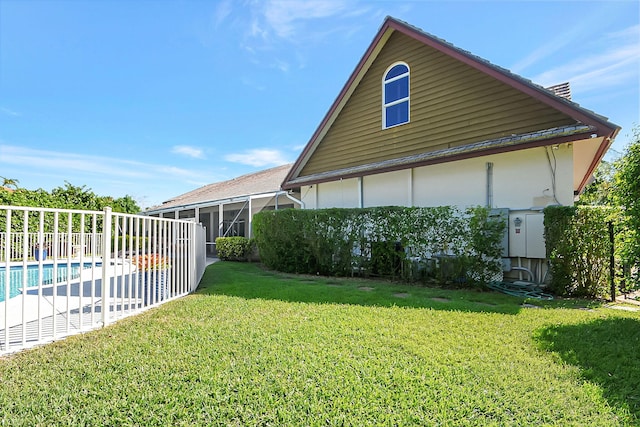 exterior space featuring a yard and a fenced in pool