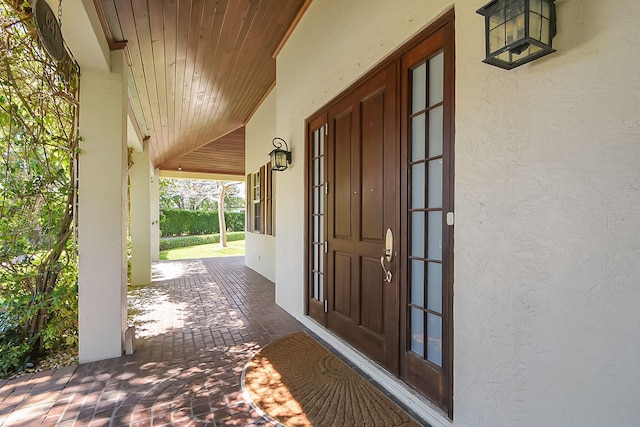 view of exterior entry with a porch