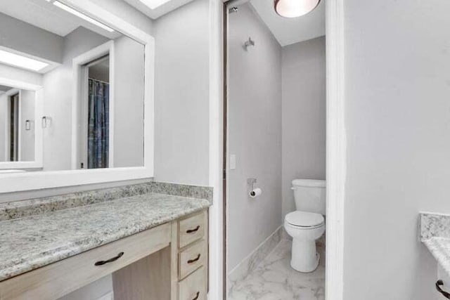 bathroom with vanity, tile patterned floors, and toilet