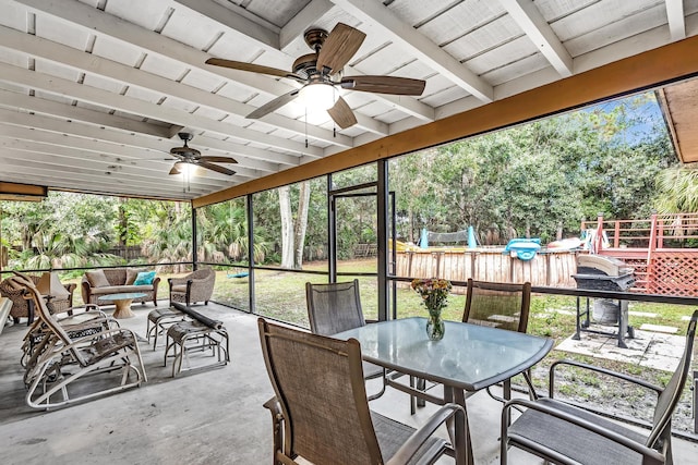 exterior space featuring ceiling fan and beam ceiling