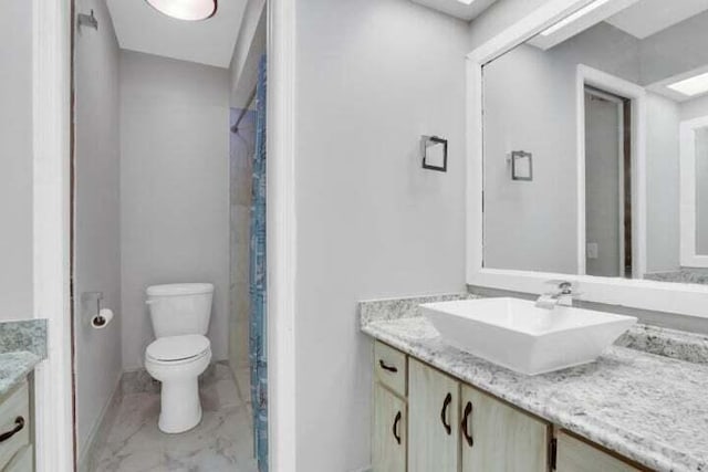 bathroom featuring vanity, tile patterned floors, and toilet