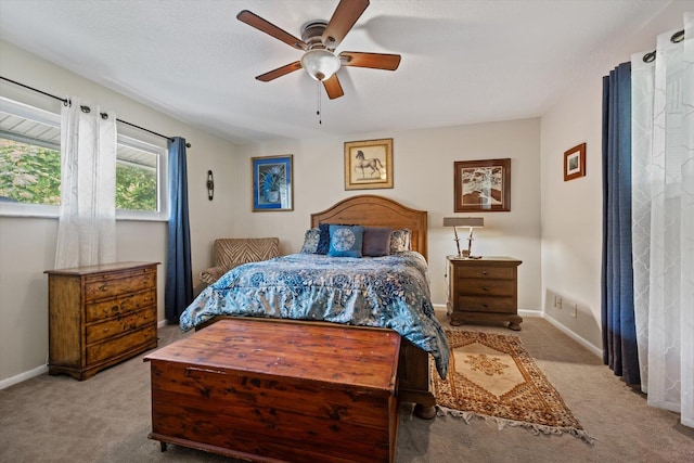 carpeted bedroom with a textured ceiling and ceiling fan