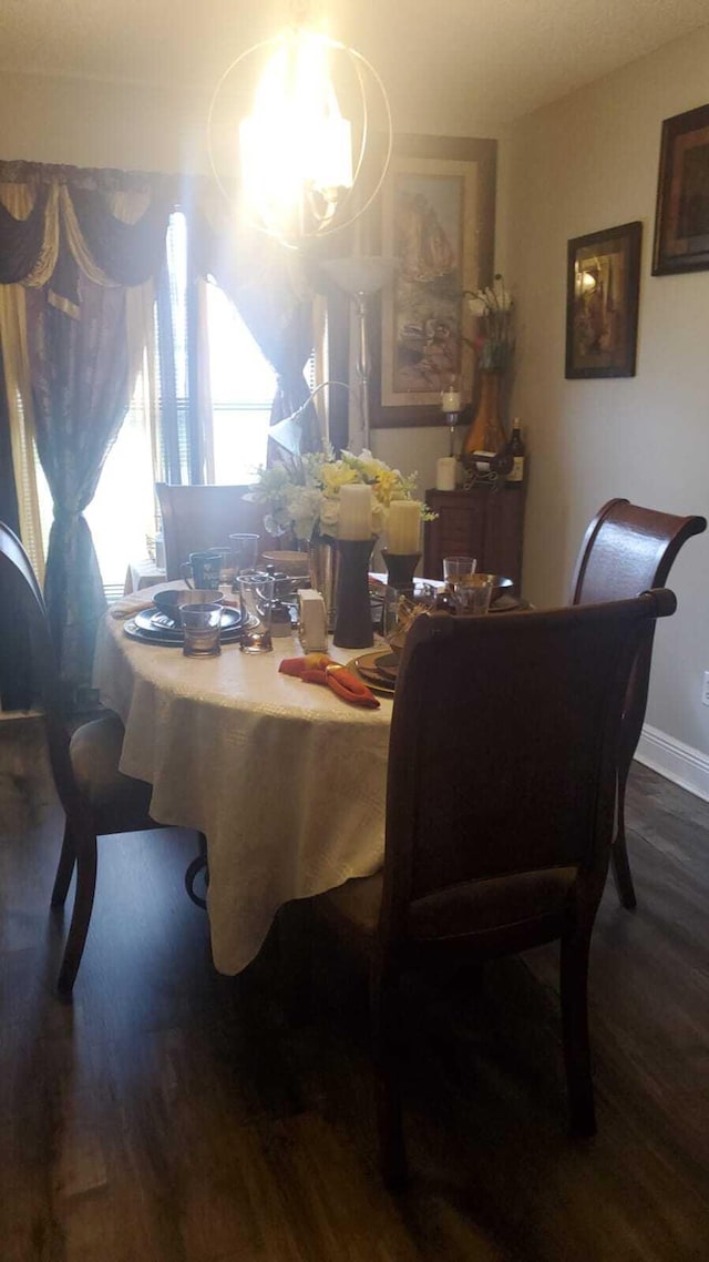 dining space with wood-type flooring