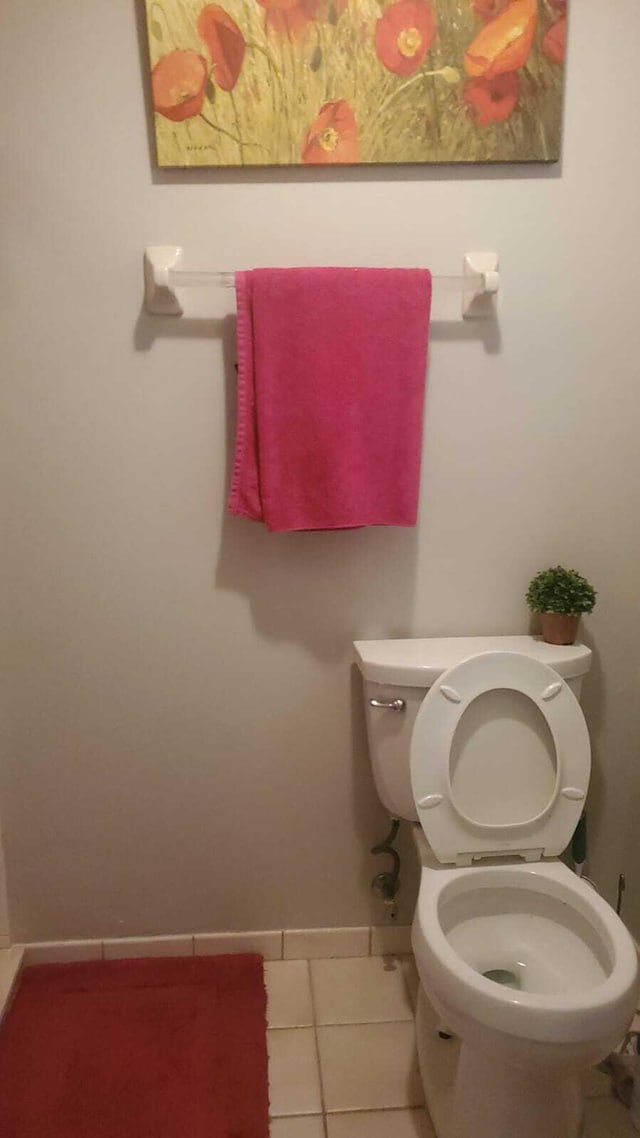 bathroom featuring toilet and tile patterned floors