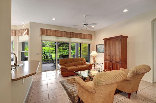 living room with light tile patterned flooring, ceiling fan, and a wealth of natural light