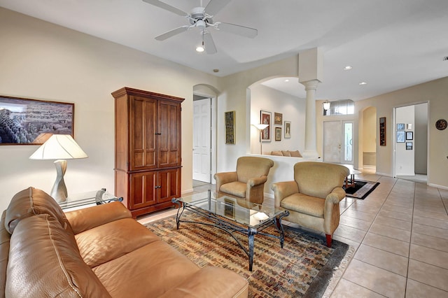 living room with decorative columns, ceiling fan, and light tile patterned floors