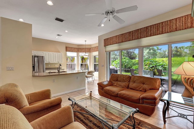 tiled living room featuring sink and ceiling fan