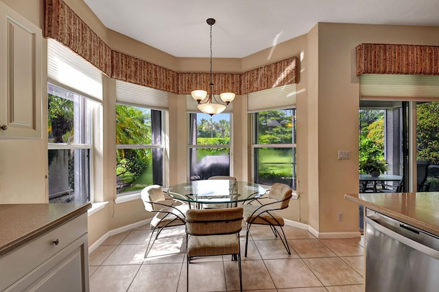 dining space featuring light tile patterned flooring and a healthy amount of sunlight