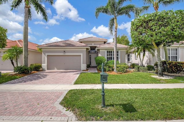 mediterranean / spanish house featuring a garage and a front lawn