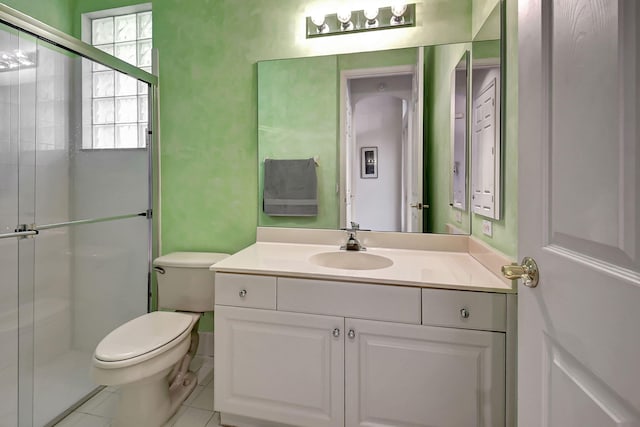 bathroom with tile patterned floors, vanity, walk in shower, and toilet