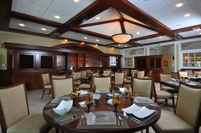 dining room featuring beamed ceiling and coffered ceiling