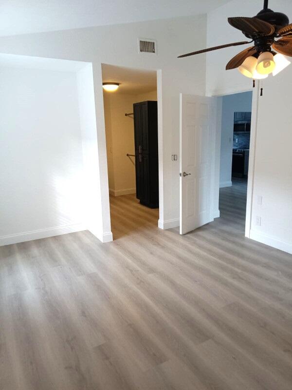 spare room with ceiling fan and hardwood / wood-style floors