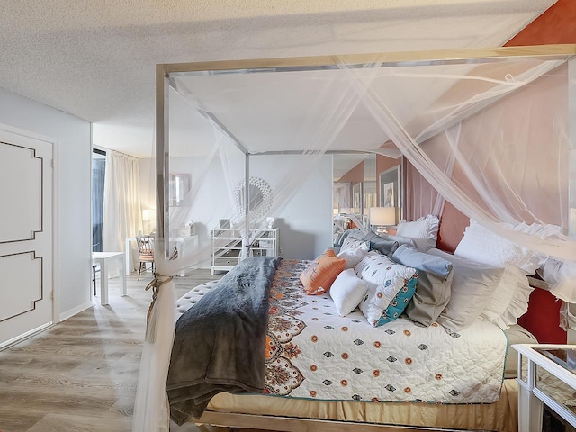 bedroom with wood-type flooring and a textured ceiling