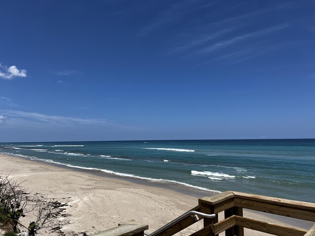 property view of water featuring a beach view