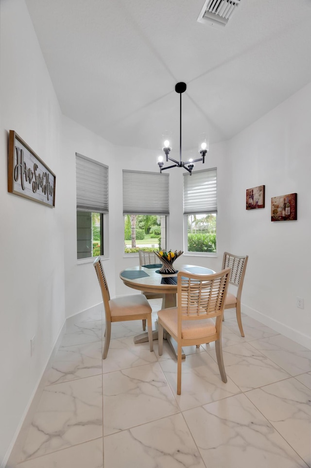 dining space featuring a healthy amount of sunlight and a chandelier