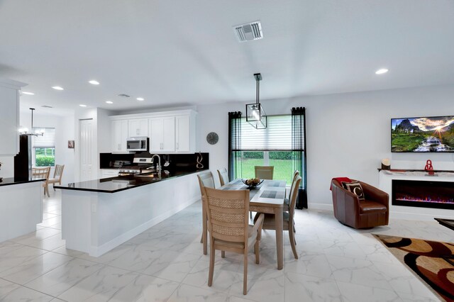 dining area with a notable chandelier and a wealth of natural light