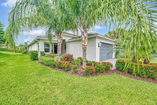 view of front of property featuring a front yard and a garage