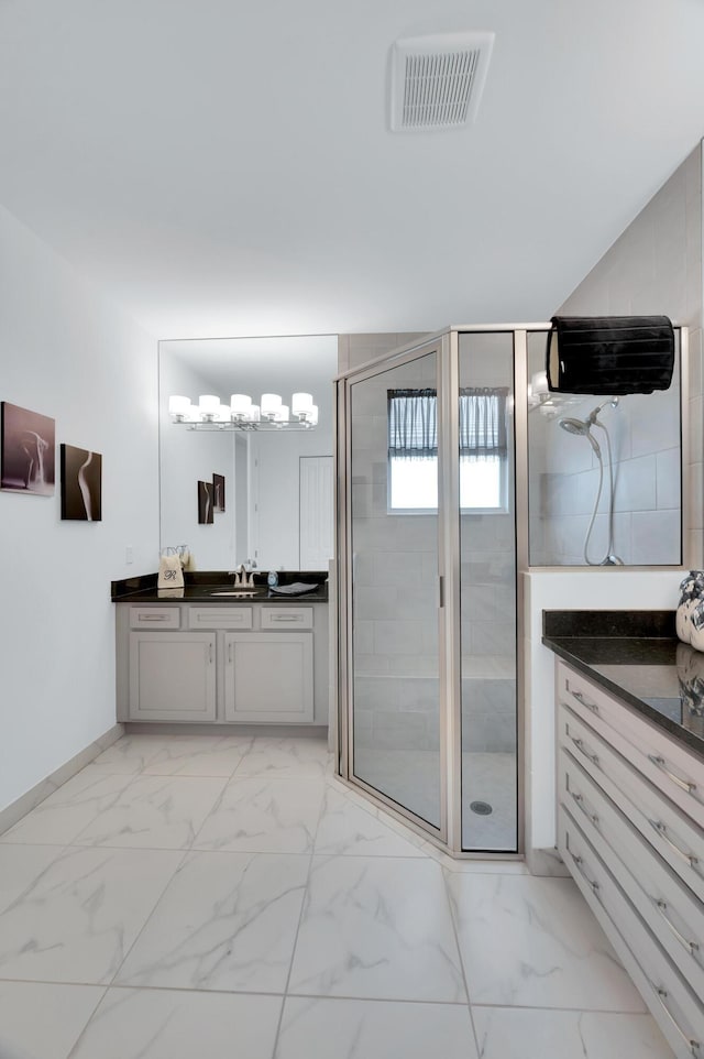 bathroom with vanity and a shower with shower door