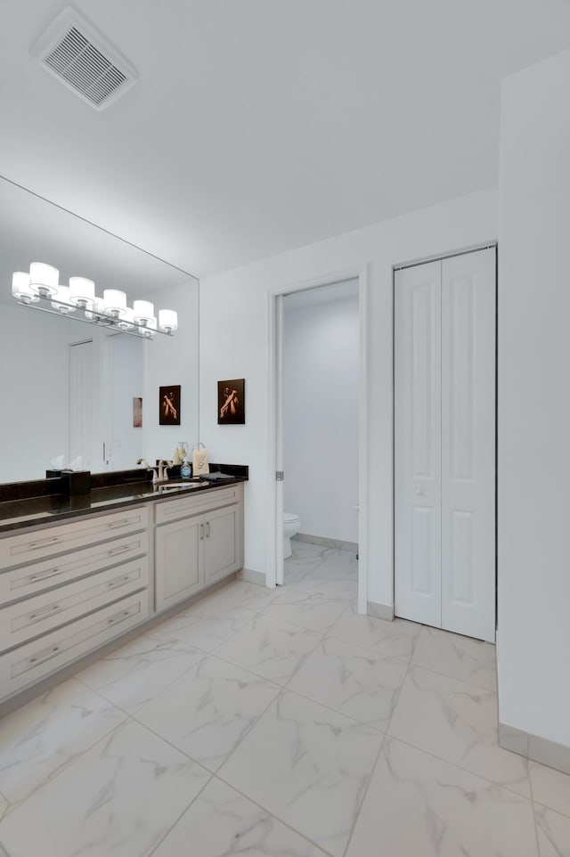 bathroom with vanity and toilet