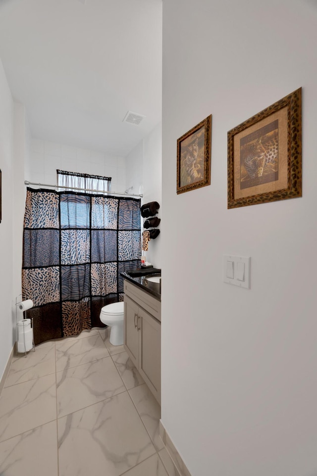 bathroom featuring toilet and vanity