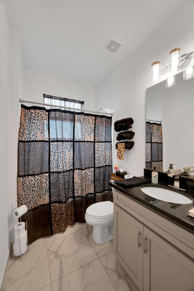 bathroom with vanity, toilet, and curtained shower