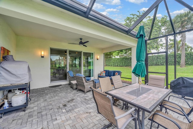 view of patio / terrace featuring outdoor lounge area, ceiling fan, and a lanai