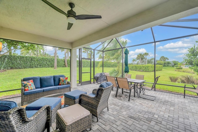 sunroom featuring ceiling fan