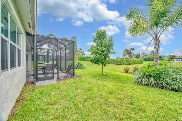 view of yard with glass enclosure