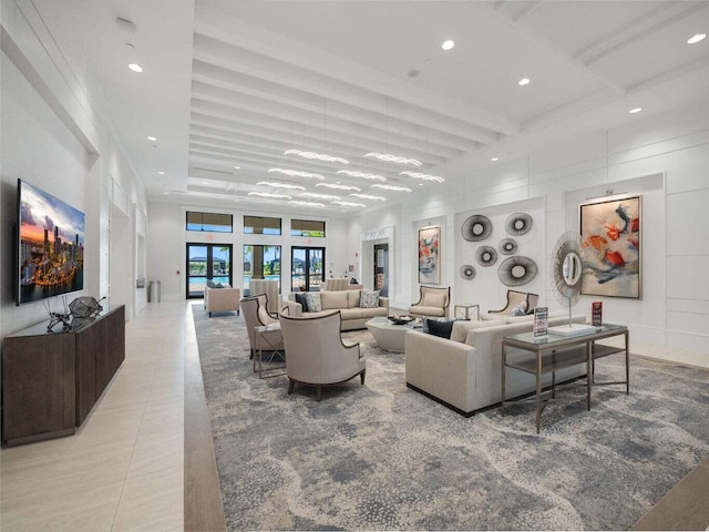 living room with beam ceiling, a high ceiling, and light tile patterned floors